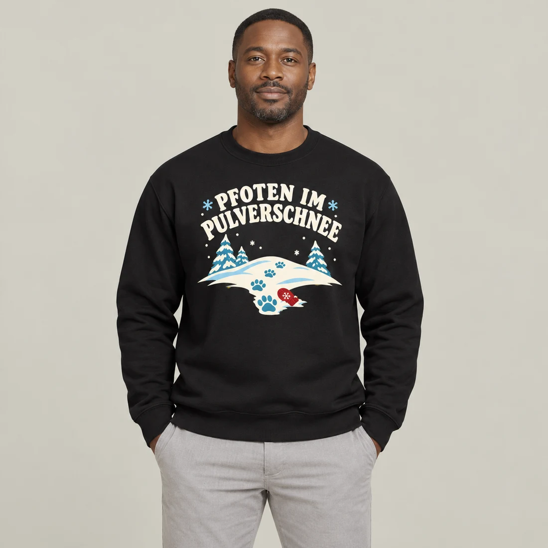 Schwarzer Unisex-Pullover: Helle Schneelandschaft mit Pfotenspuren und rotem Fäustling